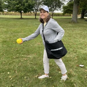 Lady using black WooshBall pitcher's bag